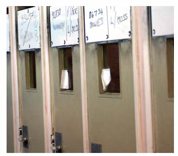 little cubicles in which prisoners are held in some prisons when they arrive from court